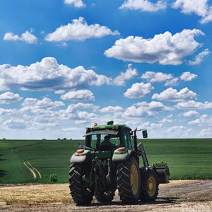 Tracteur dans les champs de blé pour la production de farine locale destinée aux biscuits LES DEUX GOURMANDS